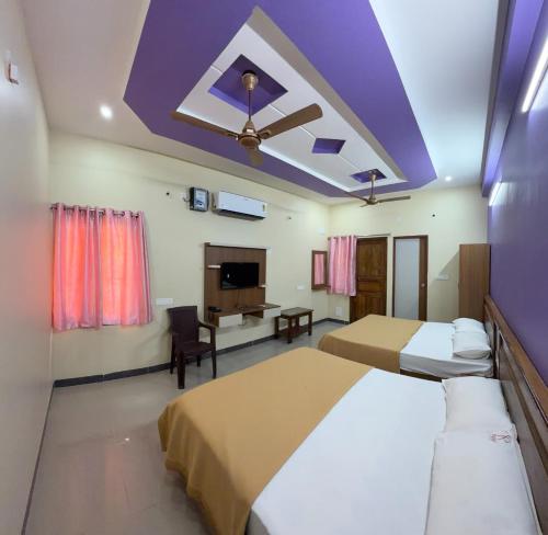 a bedroom with two beds and a purple ceiling at Gravity Groups Core - Sakthi residency in Puducherry Airpoert