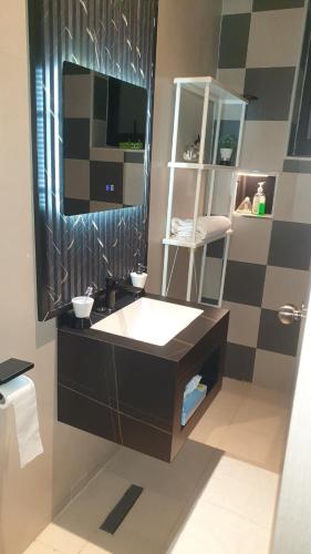 a bathroom with a sink and a mirror at Mzuri Homes in Kampala
