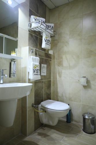 a bathroom with a white toilet and a sink at Vista Kayseri Hotel in Kayseri