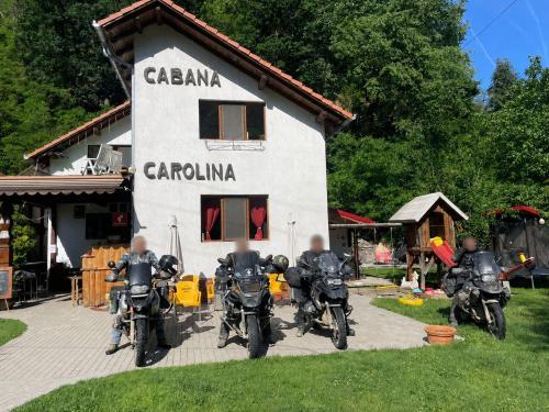 a group of motorcycles parked in front of a building at Cabana Carolina in Laz