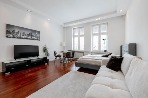 a living room with a couch and a flat screen tv at Rynek 45 Apartament in Wrocław