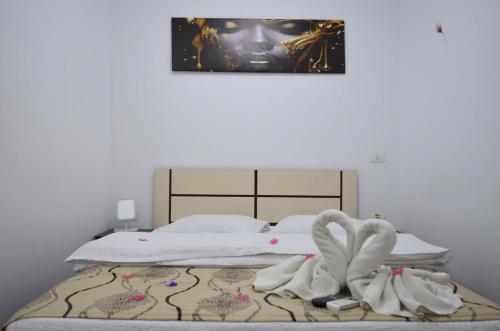 a bed with white sheets and towels on it at Razvan Holiday in Costinesti