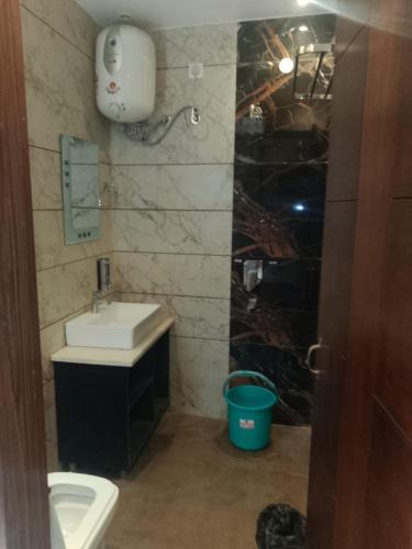 a bathroom with a sink and a toilet at Hotel Harmony in Kharar