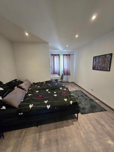 a bedroom with a bed with a comforter on it at Marien 2 Ferienwohnung Monteuerwohnung in Eppelborn