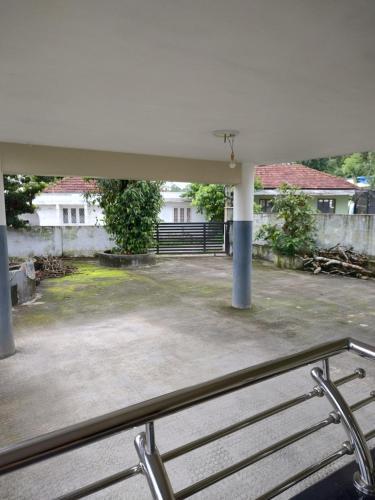 a view of a parking lot with a bench at Bridgettine Paradise 2 in Kalpetta