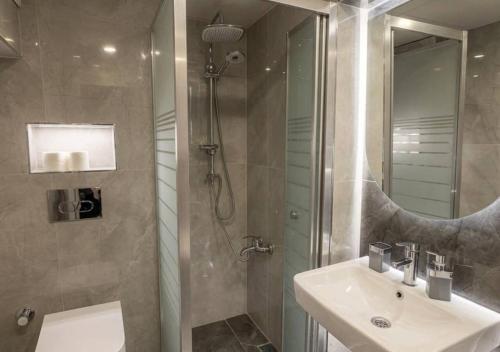 a bathroom with a sink and a shower at Hotel Tulip House in Istanbul