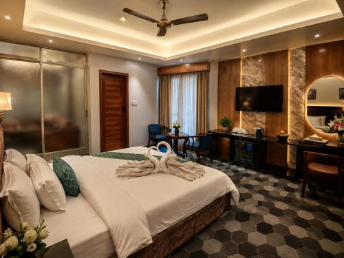 a hotel room with a bed with a towel on it at Sylhet Paradise Inn in Sylhet