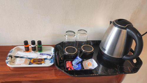 a tray with a tea kettle on top of a table at Hotel Park Royal in Pithorāgarh