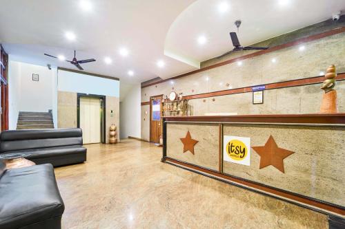 a lobby with a bar with stars on the wall at Itsy Hotels R S Bhavan, 2 Km From MIT Gate in Manipal