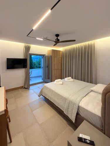 a bedroom with a bed and a ceiling fan at Centaure Inn in Agios Dimitrios