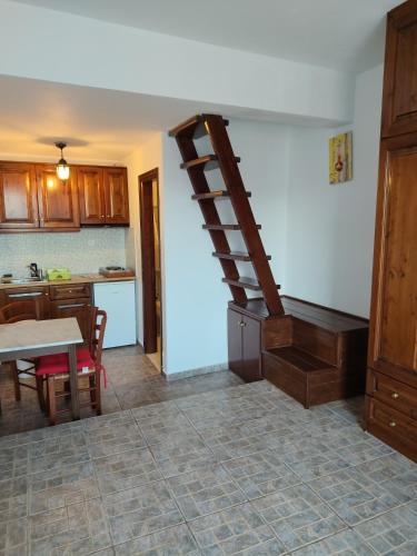 a kitchen with a spiral staircase in a room at Asvestoti ciel fish house in Astypalaia