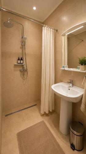 a bathroom with a sink and a shower at Baiterek Resort in Karagandy