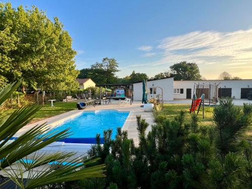 a backyard with a pool and a playground at Chez Laurie et Xavier studio 4 in Mignaloux-Beauvoir