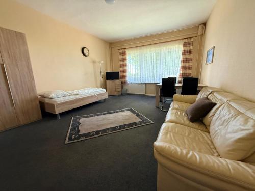 a living room with a couch and a bed at Zimmer für Monteure in Crivitz