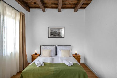 a bedroom with a bed with a green blanket at Wathay Vendégház in Csesznek