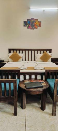 a room with a bed and a table and chairs at Brahma Heritage Resort in Pushkar