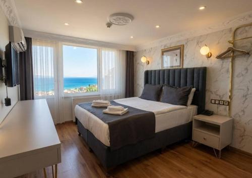a bedroom with a bed with a view of the ocean at Hotel Tulip House in Istanbul