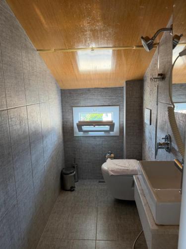 a bathroom with a white toilet and a sink at Limon Pansiyon in Kaş