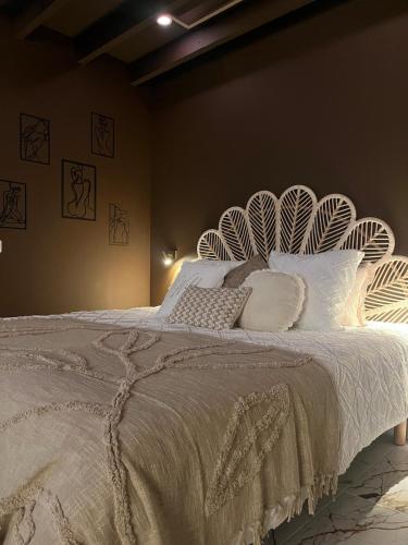 a bedroom with a large bed with white sheets and pillows at Escapade in Saint-Jouin-Bruneval