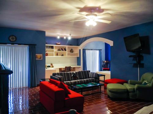 a living room with two couches and a flat screen tv at La Posada Del Tepeyac in La Paz