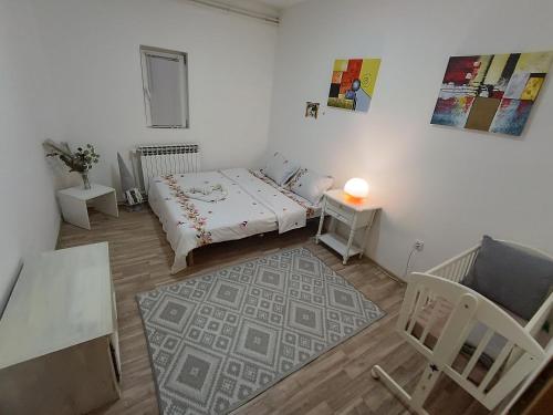 a small bedroom with a bed and a table at Mountain Relax Vlašić in Vlasic