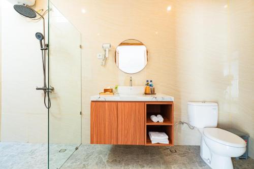 a bathroom with a sink and a toilet and a shower at Dita Villa Uluwatu in Bingin Beach
