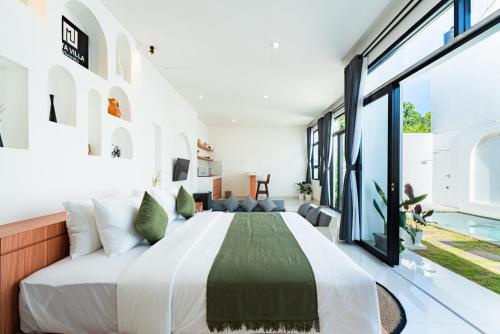 a bedroom with a large bed and a pool at Dita Villa Uluwatu in Bingin Beach
