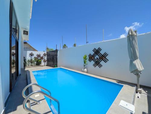 a swimming pool in the backyard of a house at Villa Goli 3BR Private Pool Villa, Paje in Zanzibar City