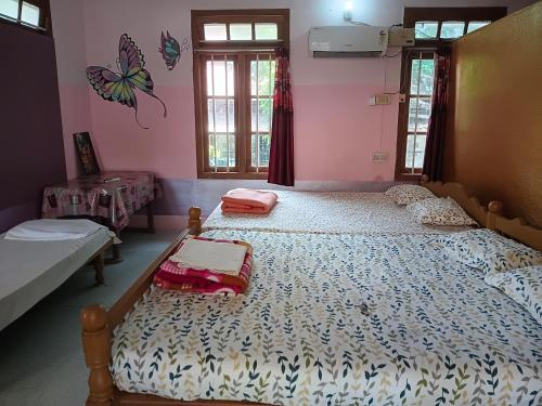 a bedroom with two beds and two suitcases at First Alleppey homestay in Alleppey