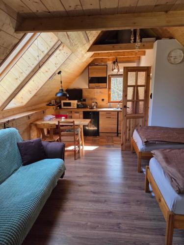 a living room with a couch and a table at Dolina Izerów in Sucha