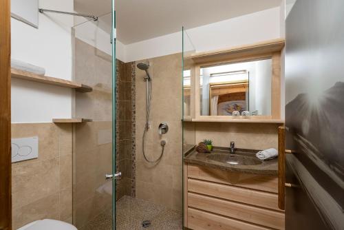a bathroom with a shower and a sink at Moarlhof - Farm Nature Resort in Castelrotto