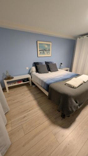 a bedroom with a large bed and a wooden floor at HOME HOSE in Monistrol-sur-Loire