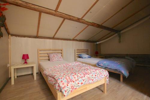 a bedroom with two beds in a room at Gîte BELLA in Ebly