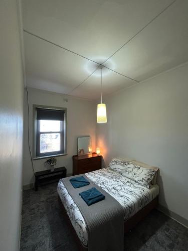 a bedroom with a large bed and a window at Tailem Bend Hotel in Tailem Bend