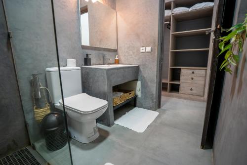 a bathroom with a toilet and a sink at Villa Cactus in Ben Larbi