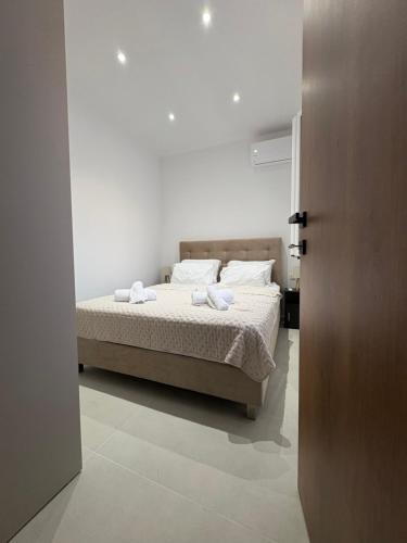 a bedroom with a bed with two towels on it at Makridakis apartments in Rethymno