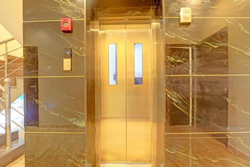 a elevator in a building with a glass door at FabHotel Royal Atlantis Studio Apartments in Chennai