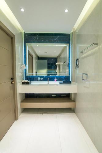 a bathroom with a sink and a mirror at Twelve Hotel in Baghdād