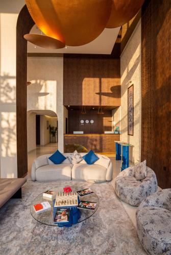 a living room with two couches and a cake on a table at Twelve Hotel in Baghdād