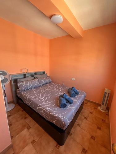 a bedroom with a bed with blue towels on it at Las Delicias de Estepona in Estepona