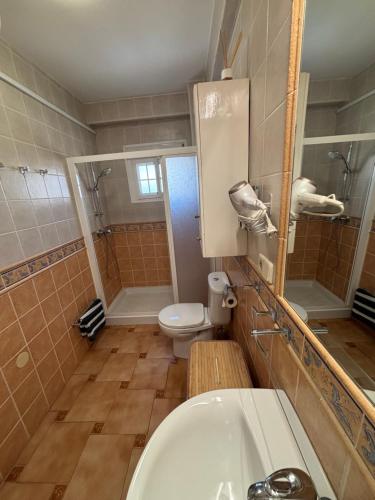 a bathroom with a sink and a toilet and a mirror at Las Delicias de Estepona in Estepona