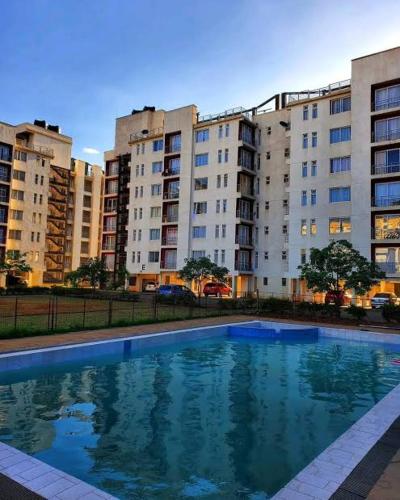 a large swimming pool in front of some buildings at Luxe Haven in Nairobi