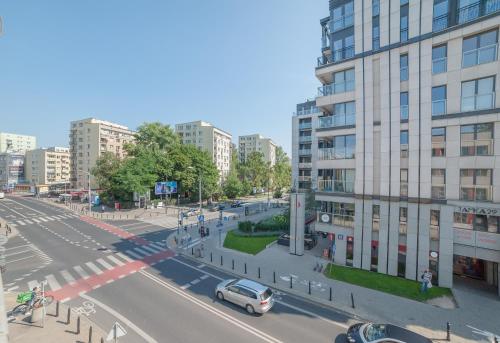 a city street with cars on the road and buildings at Tatamka Hostel in Warsaw