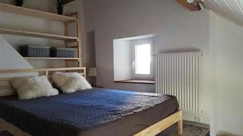 a bedroom with a bed and a window at Joly Gîte in Les Bois