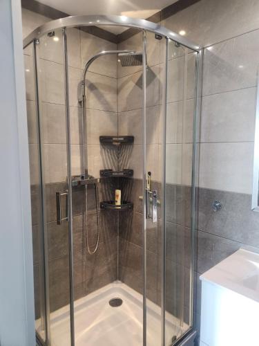 a shower with a glass enclosure in a bathroom at Chambre d hote in Le Tignet