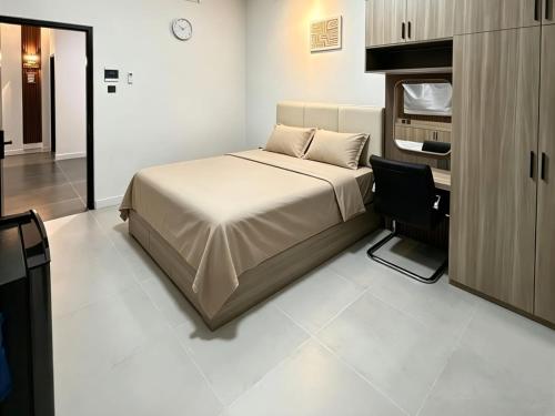 a bedroom with a bed and a chair in it at D'CIA Coliving in Kejayan