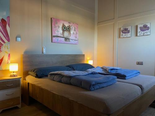 a bed with blue pillows on it in a bedroom at Finca Tolomó in Aspe