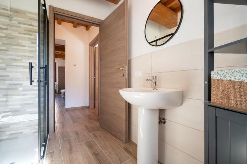 a bathroom with a sink and a mirror at L'appartamento azzurro cielo in Fanano