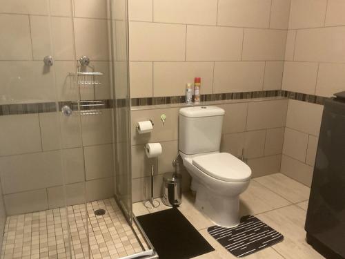a bathroom with a toilet and a shower at Katima VVIP in Katima Mulilo