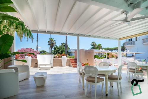 a patio with a white table and chairs at Hotiday San Felice Circeo in San Felice Circeo